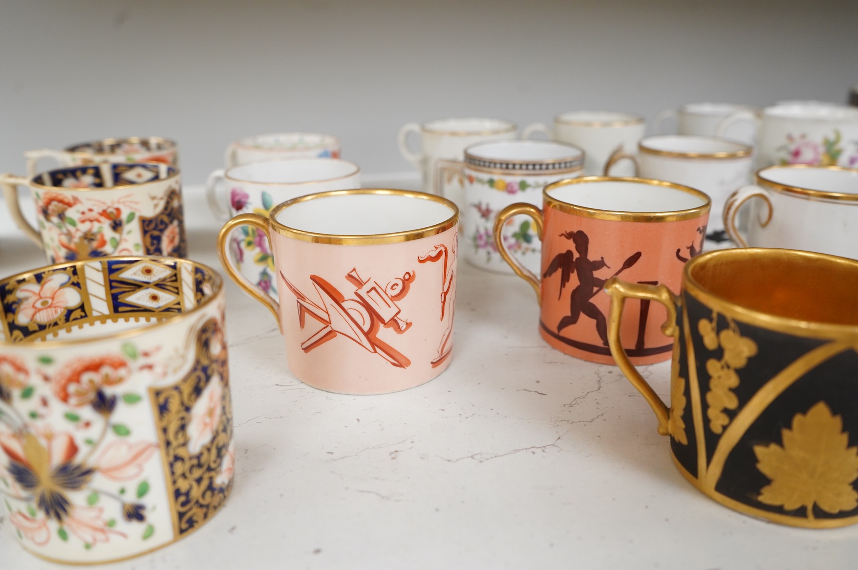 A collection of late 18th/19th century English and French porcelain coffee cans, tea cups and vases, some in Imari pattern